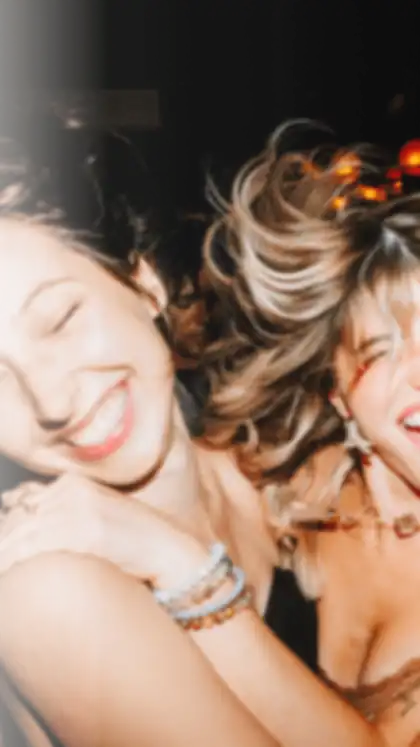 Partiful short-form post: a group of friends laughing together at a party, close and out of focus.